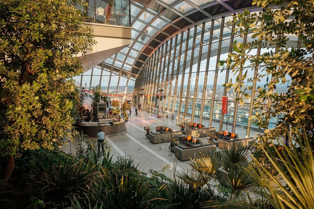 The planted terraces and glass roof of Sky Garden, with lounge seating by the windows