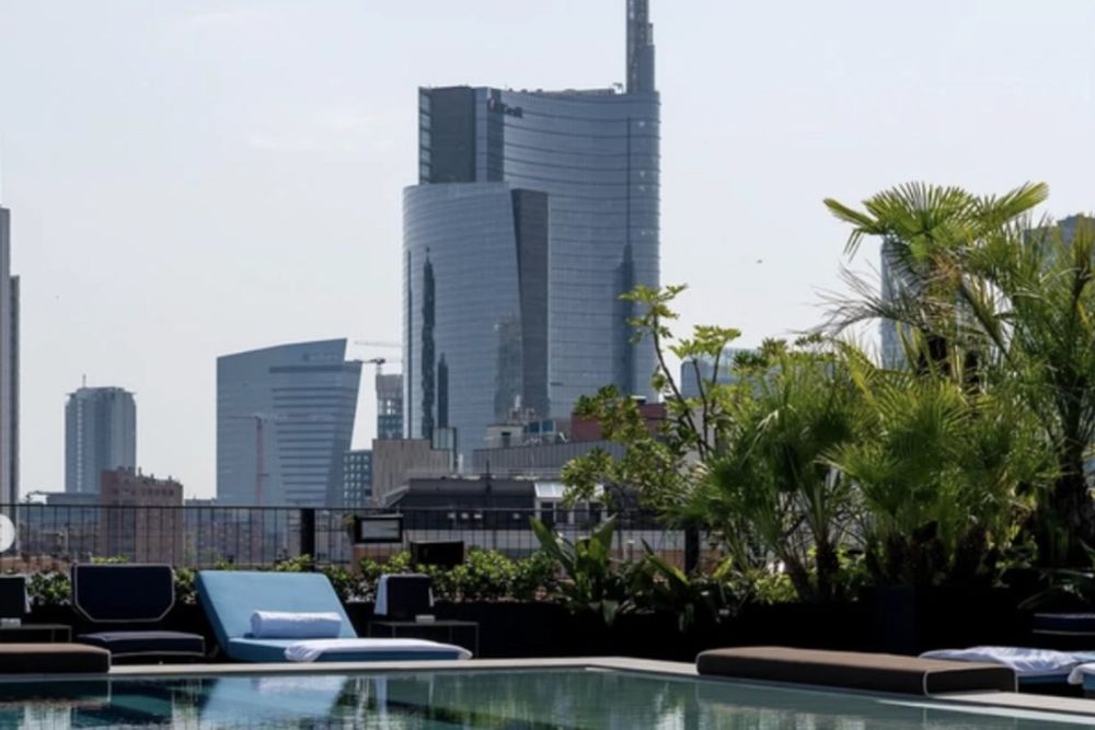 The Ceresio 7 rooftop pool with the Porta Nuova skyscrapers behind