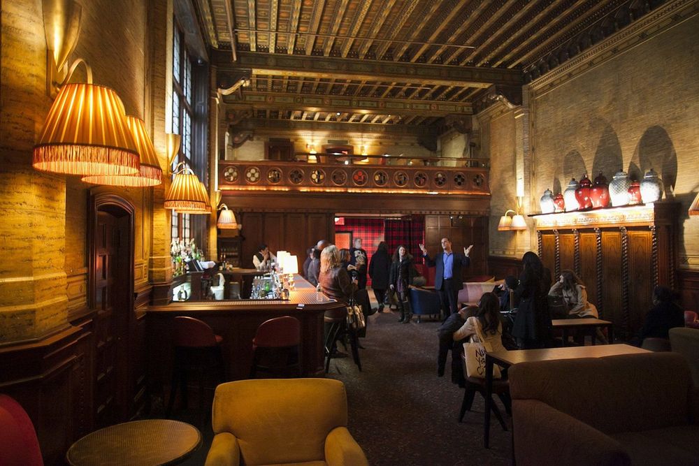 The beamed ceiling, lamps and armchairs of The Campbell in Grand Central Terminal