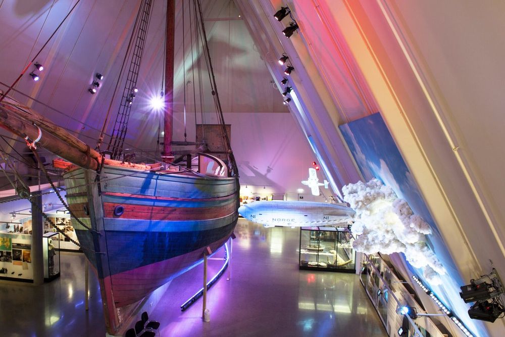 Amundsen's ship Gjøa in its exhibition hall at the Fram Museum, lit in blue and violet