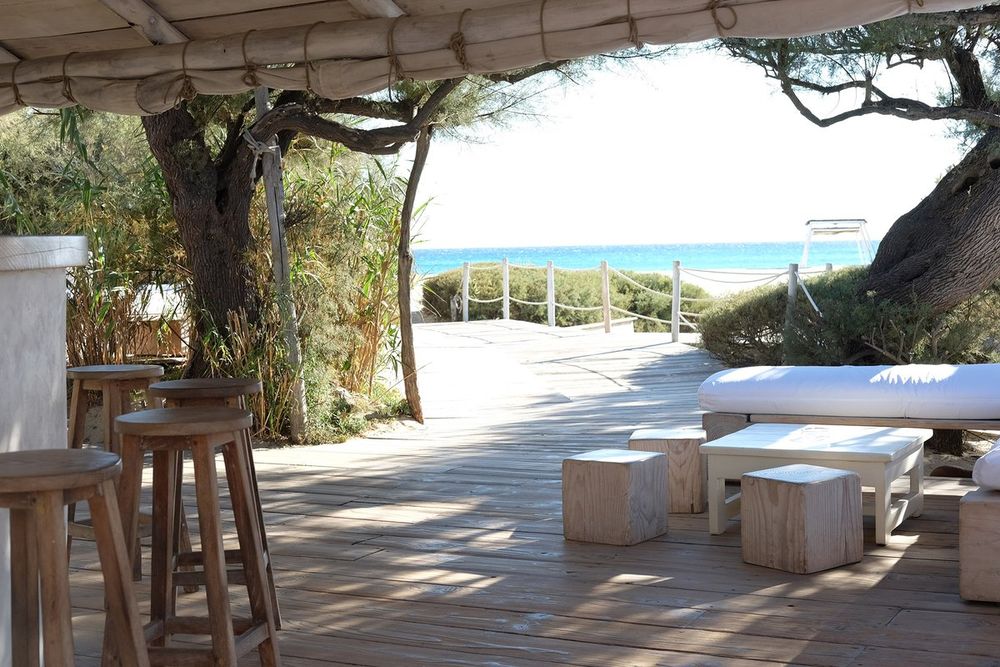 The shaded wooden terrace of Club 55 opening onto the beach at Pampelonne