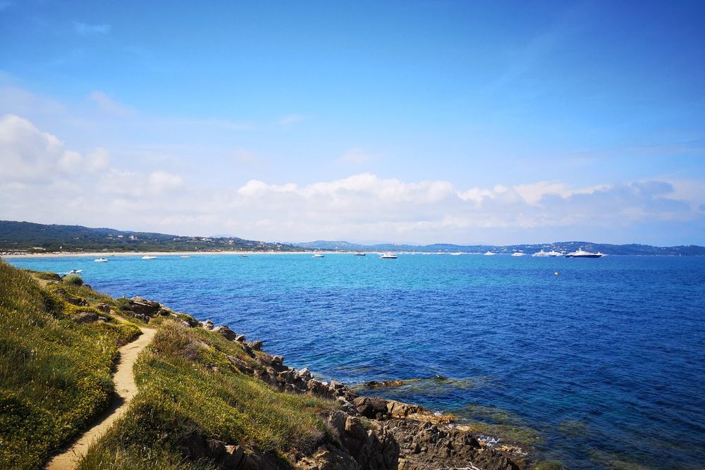 The coastal path running through scrub above the blue sea south of Bonne Terrasse