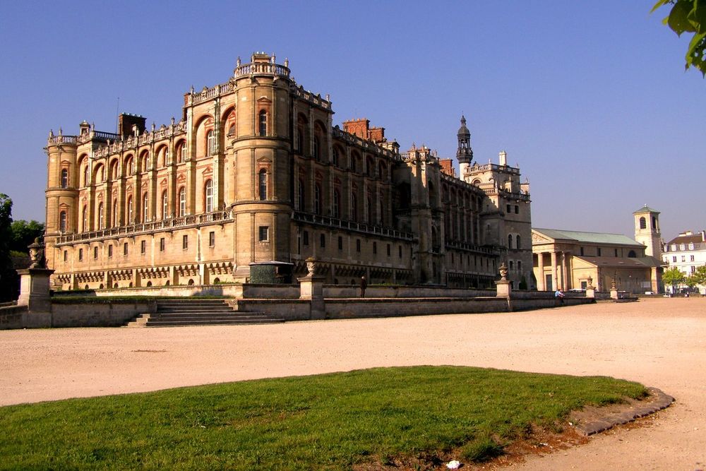 The brick and stone château of Saint-Germain-en-Laye in evening light across its forecourt