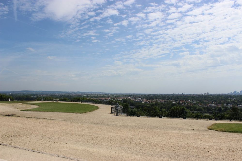 The wide gravel Grande Terrasse at Saint-Germain-en-Laye with the Seine valley and the towers of La Défense on the horizon