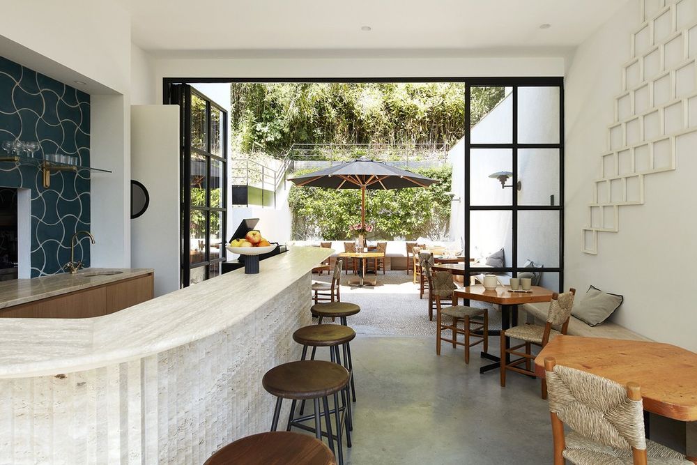 The bar and tables of Restaurant SOL opening on to its garden terrace at the Fondation CAB