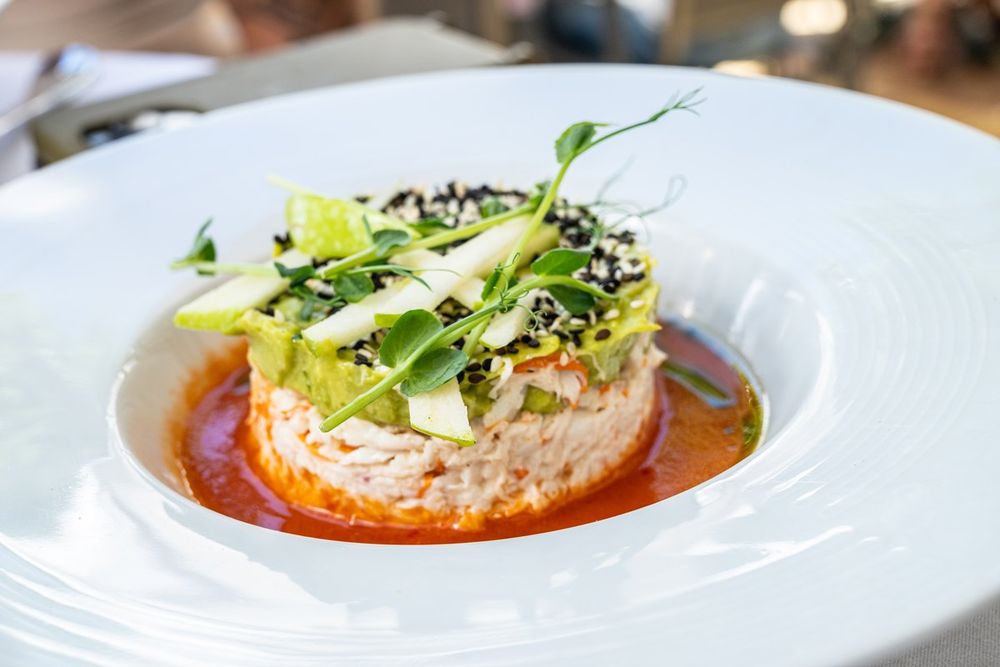 A plated starter of crab and avocado in a tomato coulis at the Excelsior restaurant