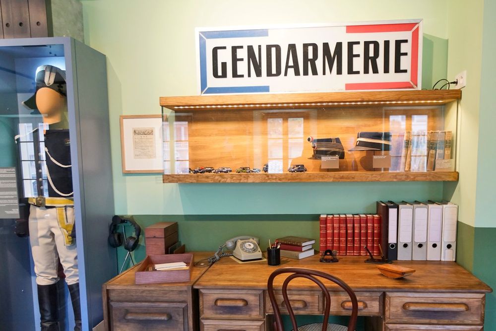 The reconstructed 1960s gendarmerie office with a uniformed mannequin in the Musée de la Gendarmerie et du Cinéma
