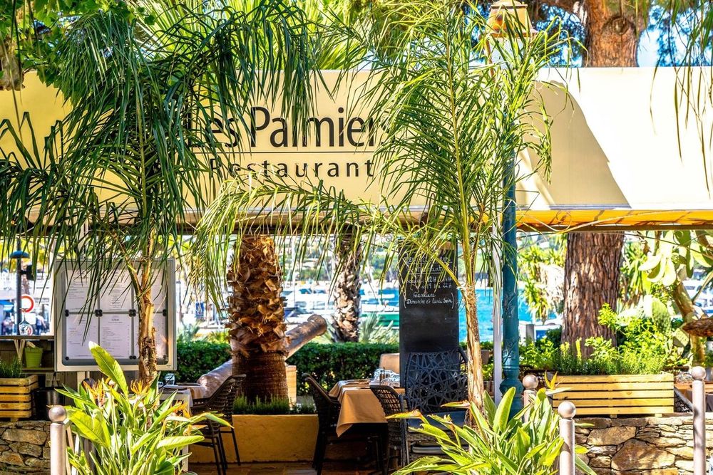 Palms and planters at the entrance to Les Palmiers restaurant, overlooking the port of Sainte-Maxime
