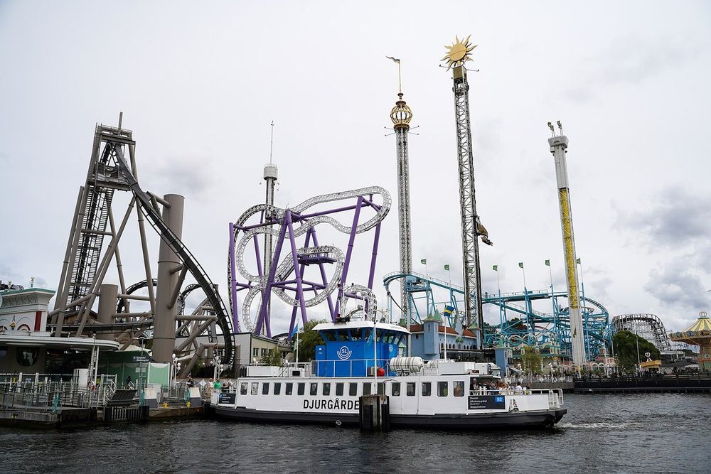 The Djurgården ferry passing beneath the rides of Gröna Lund on a grey day