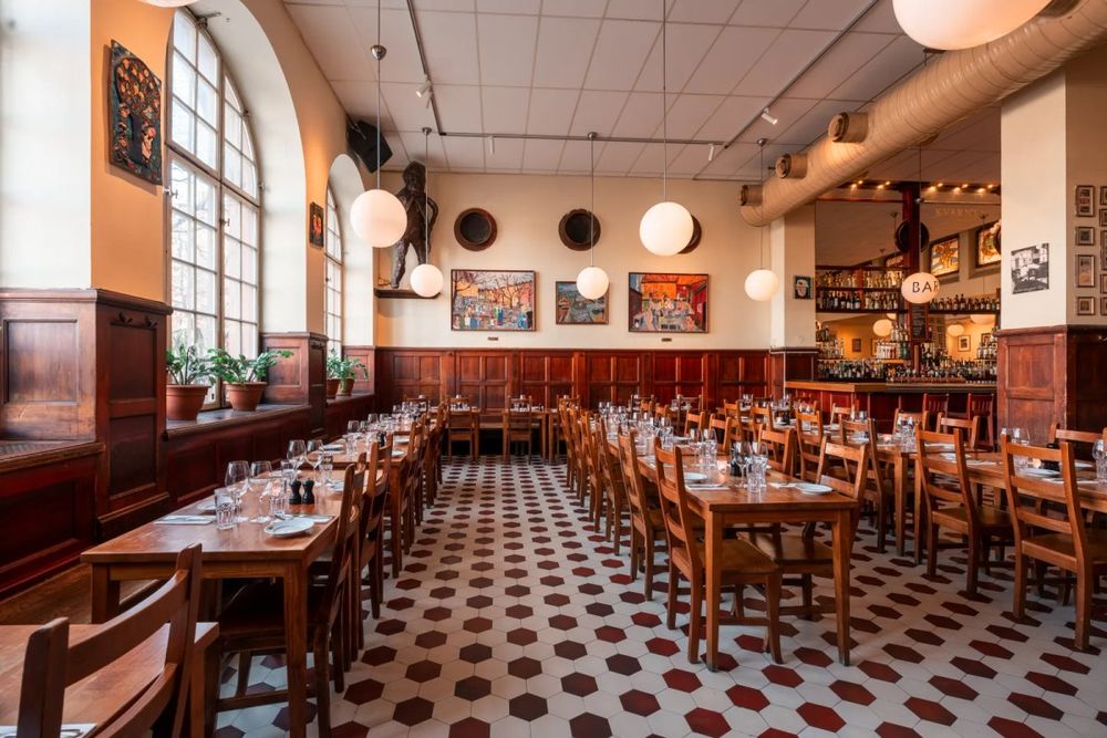 The long beer hall at Kvarnen with its chequered floor, wooden tables and globe lamps