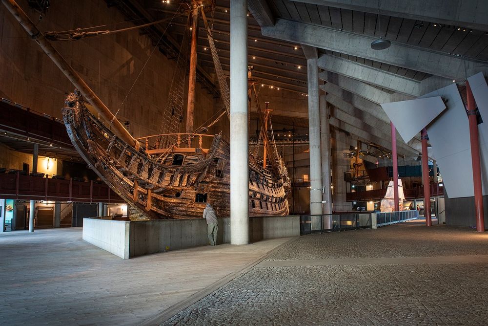 The warship Vasa, masts and rigging rising into the dim hall of the Vasa Museum