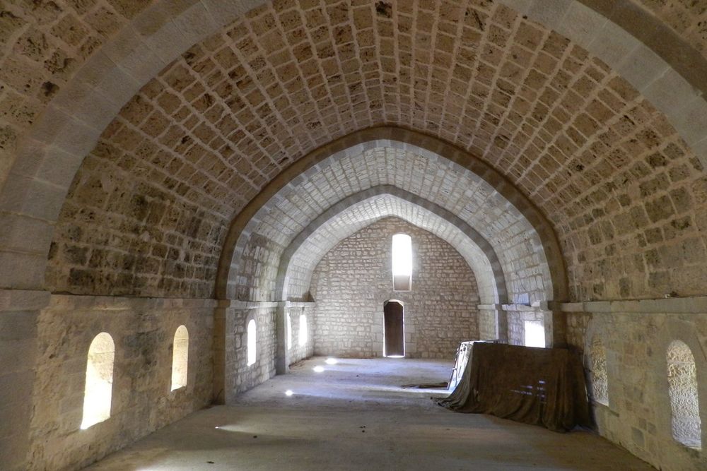The bare Romanesque stone vault of a hall in the former abbey of Valbonne