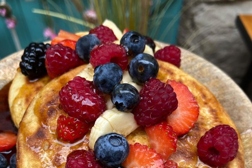Pancakes heaped with berries and banana from the brunch menu at Garinette