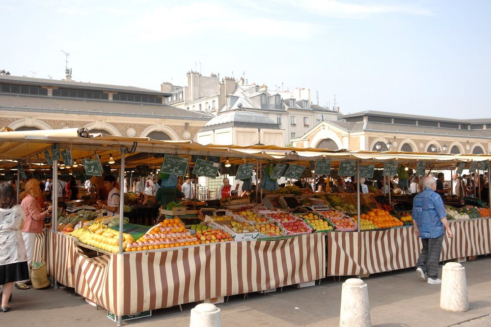Fruit and vegetable stalls under striped awnings in the open-air Carrés of the Marché Notre-Dame, Versailles