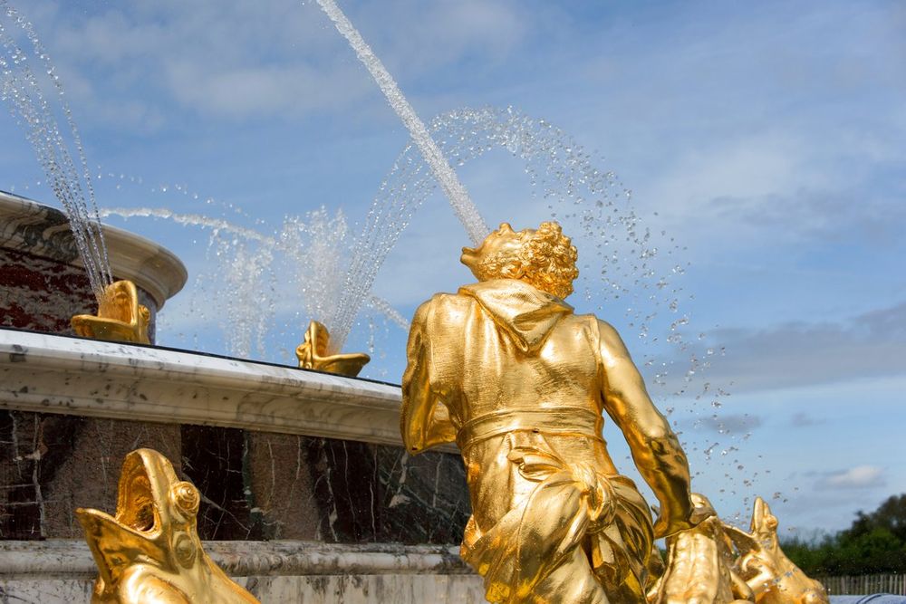 Gilded sculpture and jets of water during the Musical Fountains Show in the Gardens of Versailles