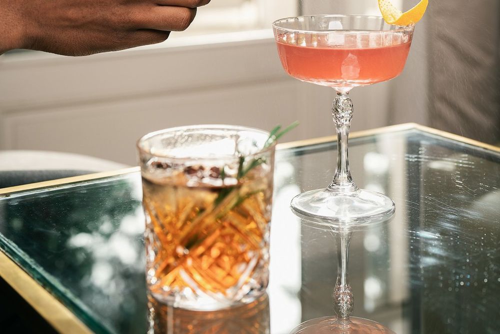 Two cocktails on a mirrored table at the Peacock Alley bar of the Trianon Palace in Versailles
