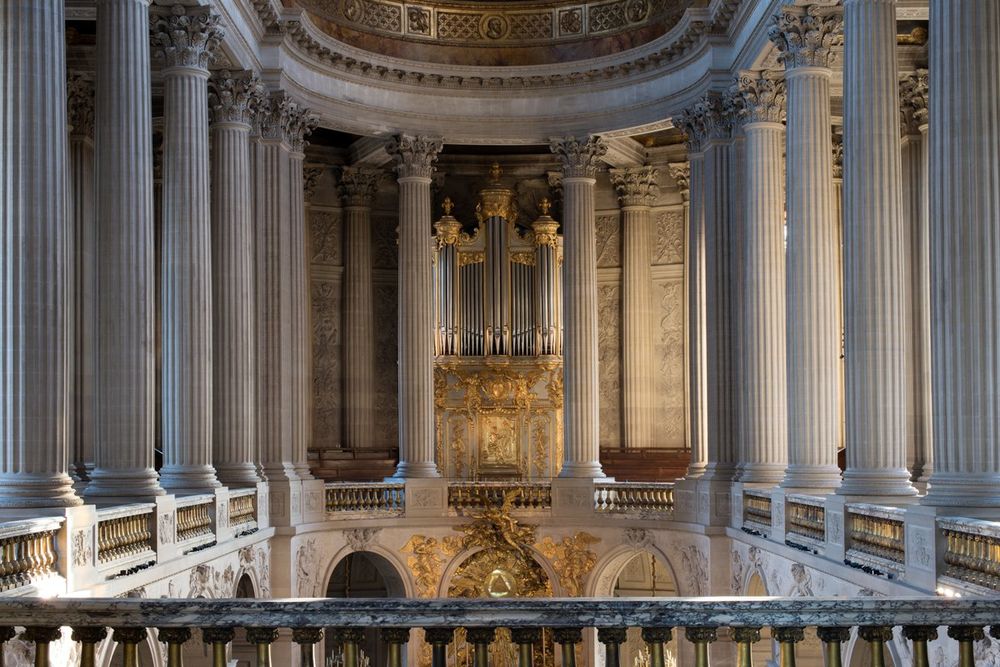 The white columns and organ of the Royal Chapel at the Palace of Versailles